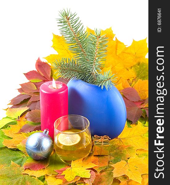 Autumn cognac with lemon Christmas leaves wild grapes and maple burning red candle and christmas-tree decorations on white background. Autumn cognac with lemon Christmas leaves wild grapes and maple burning red candle and christmas-tree decorations on white background