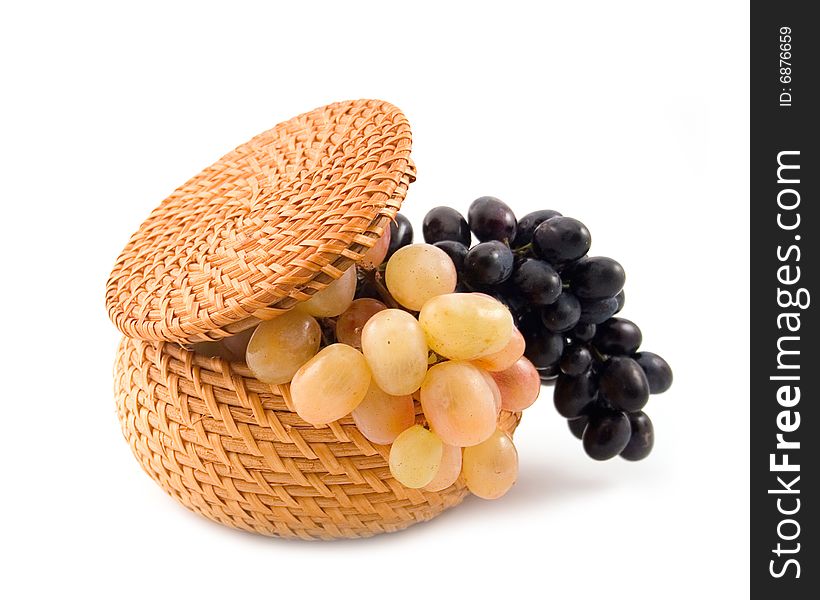 Yellow wum basket  with yellow and black grapes on  white background. Yellow wum basket  with yellow and black grapes on  white background