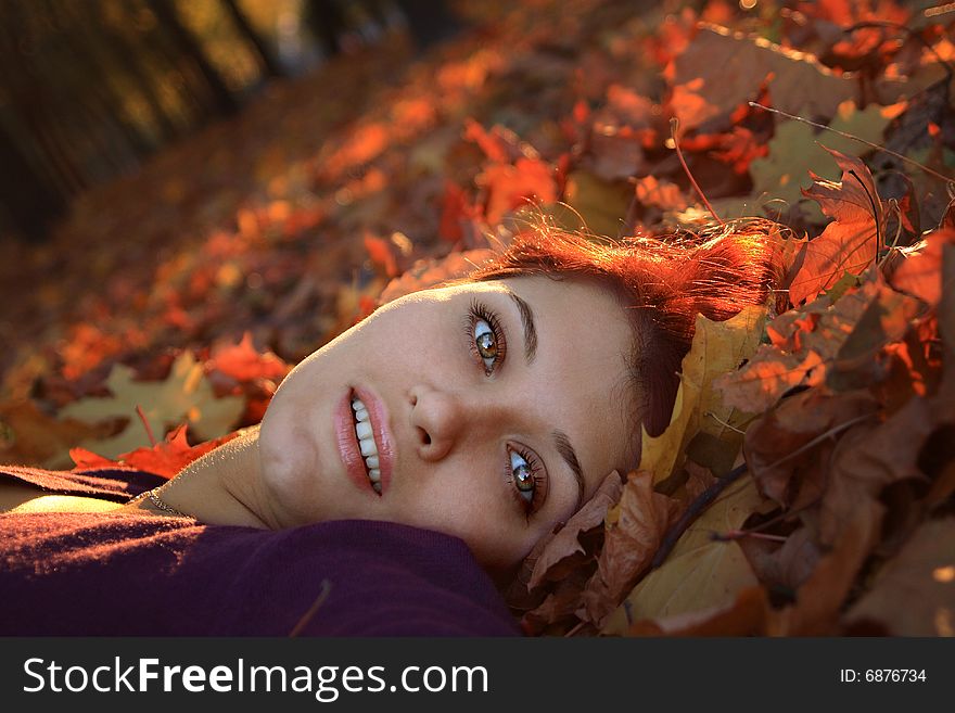Girl laying in autumn leaves. Girl laying in autumn leaves