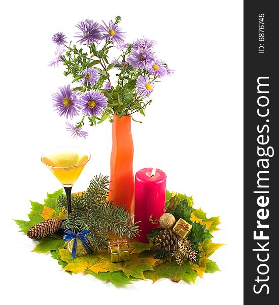 Bouquet colors orange decorative vase on autumn leaves with burning red candle and New Year's ornaments on white background. Bouquet colors orange decorative vase on autumn leaves with burning red candle and New Year's ornaments on white background