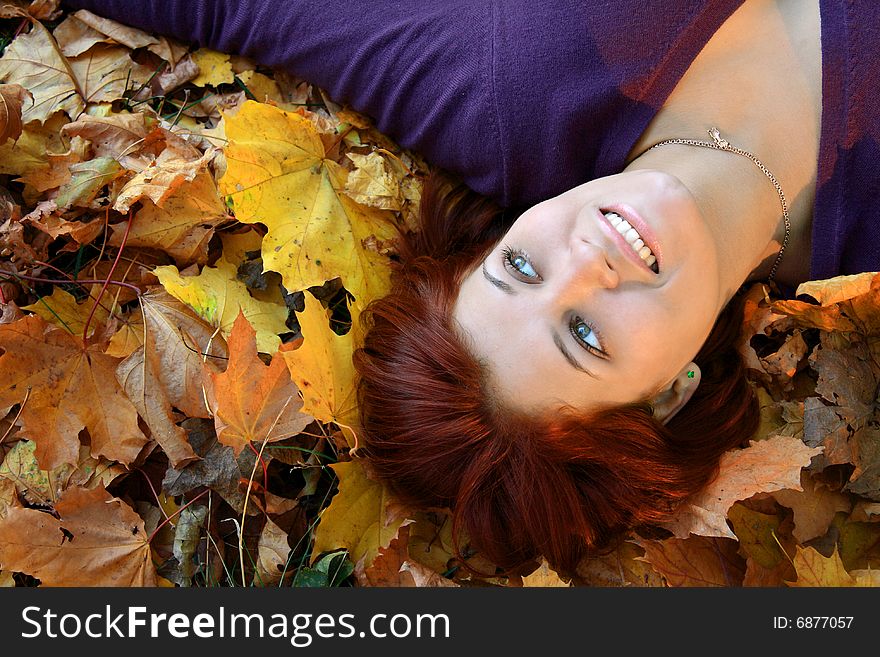 Girl laying in autumn leaves. Girl laying in autumn leaves