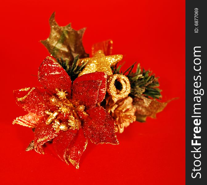 A christmas decoration with a red flower and a golden star