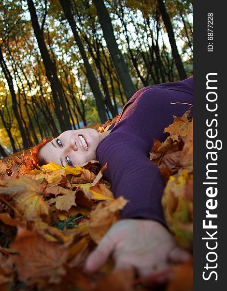 Girl laying in autumn leaves. Girl laying in autumn leaves