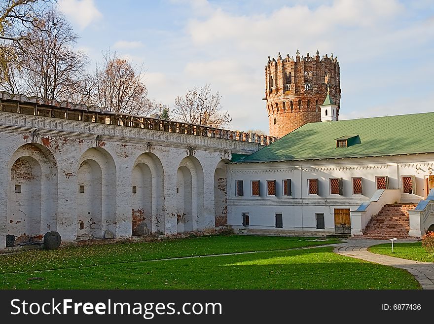 Courtyard of an ancient monastery with a fortification and a tower. Courtyard of an ancient monastery with a fortification and a tower
