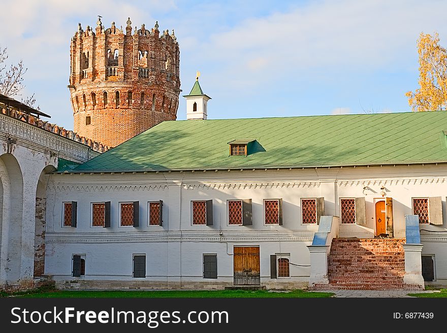 Courtyard of the ancient monastery walls house with a green roof and tower. Courtyard of the ancient monastery walls house with a green roof and tower