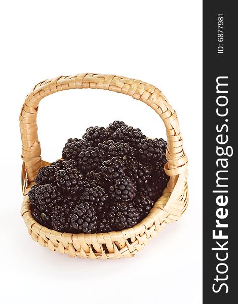 Fresh blackberries in a basket on bright background. Fresh blackberries in a basket on bright background