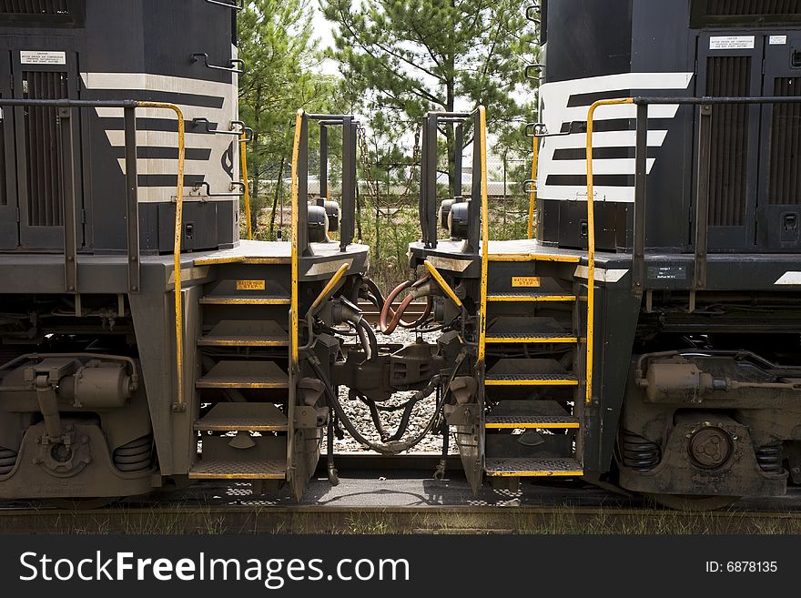 Two train locomotive engines coupled together in the front. Two train locomotive engines coupled together in the front