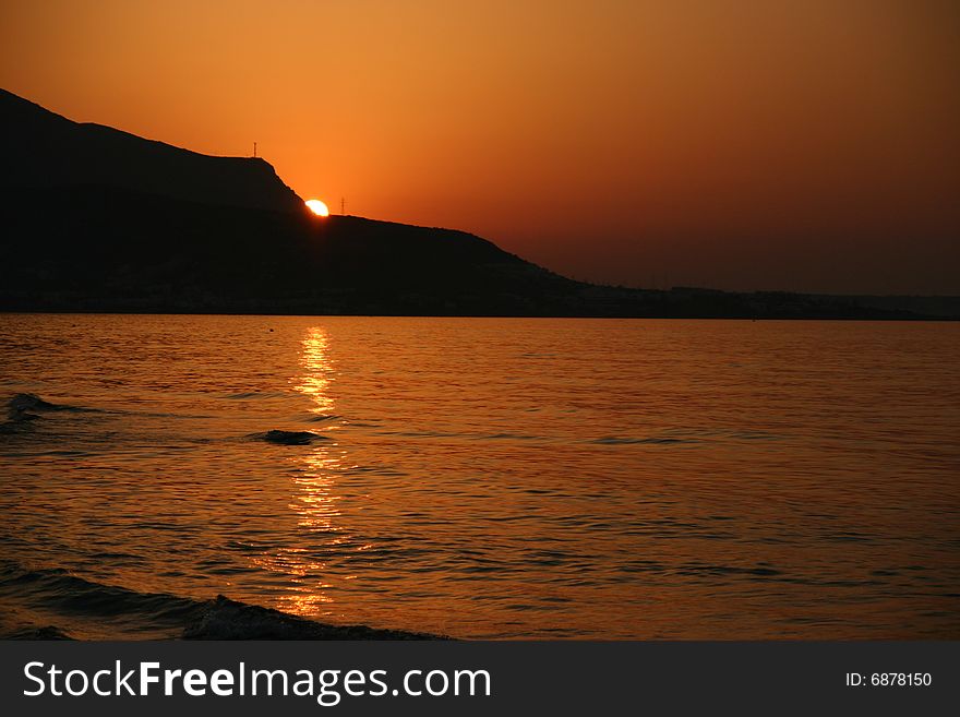 A photo of a beach and a mountain on the background. A photo of a beach and a mountain on the background