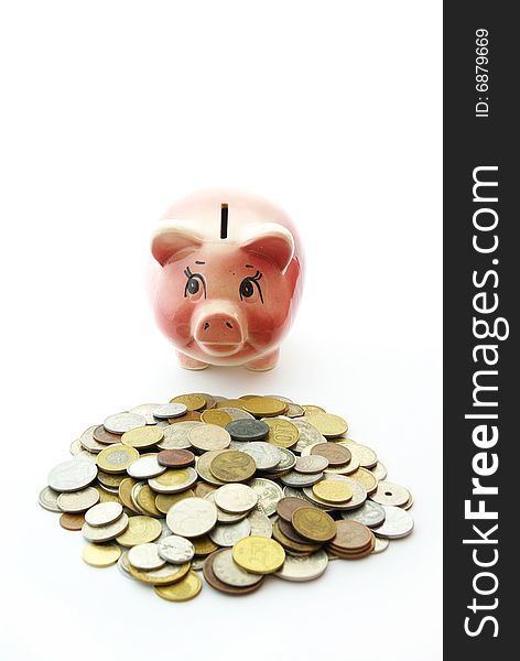 Pink piggy bank  isolated on white background with coins