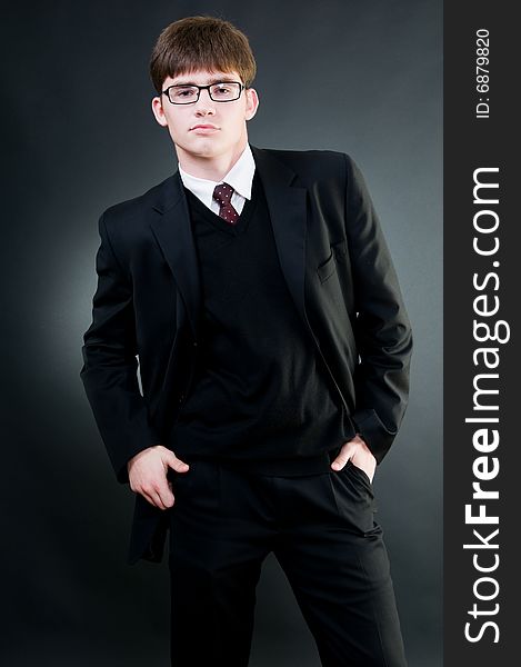 Young handsome businessman in black suit