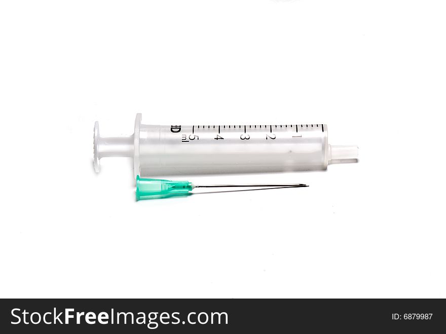 Syringe with a needle on the white isolated background