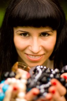Young Brunette Holding A Lot Of Beads Royalty Free Stock Images Young Brunette Holding A Lot Of Beads Royalty Free Stock Images