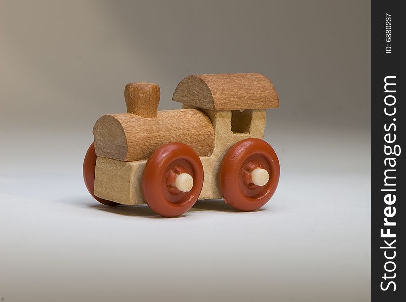 Wooden toy train on a light background