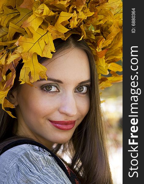 A young beautiful woman wearing a leaf wreath on her head. A young beautiful woman wearing a leaf wreath on her head.
