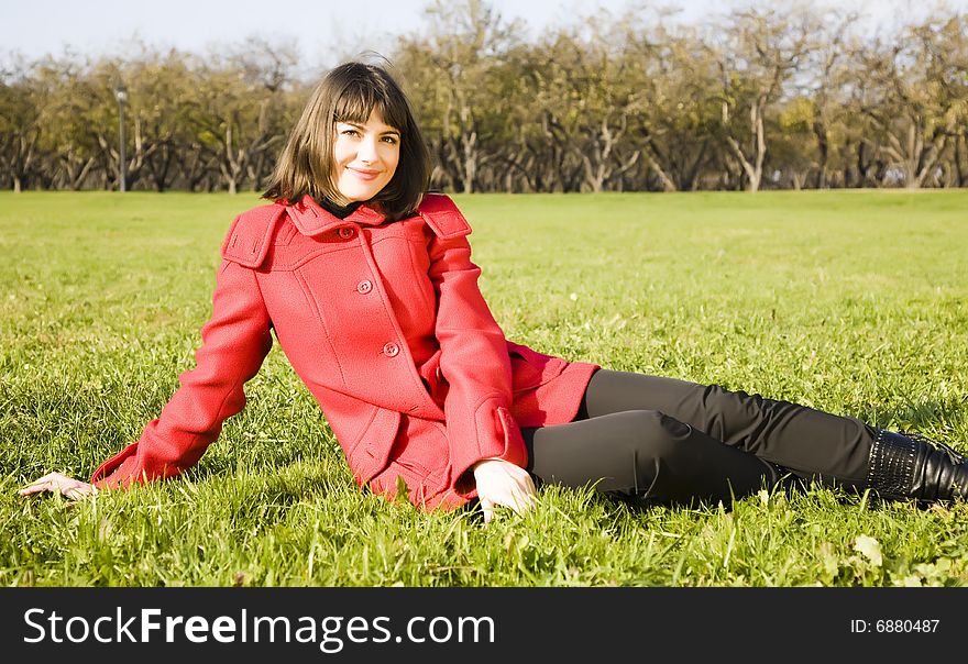 Young Woman Sitting On The Grass