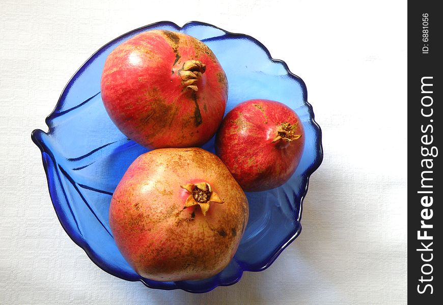 Three fresh pomegranate on table