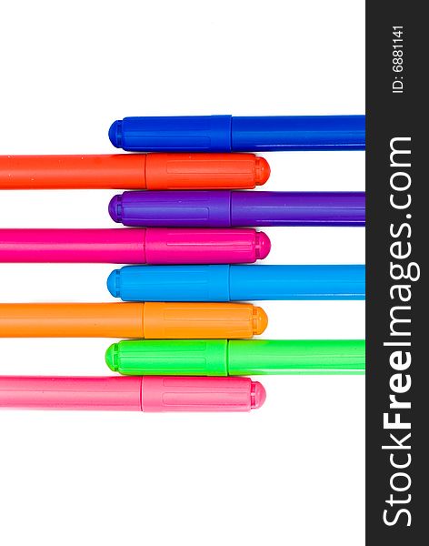 Varicoloured markers on the white isolated background