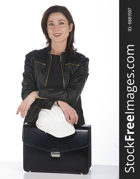 A pretty woman architect with a bag in office smiling. A pretty woman architect with a bag in office smiling