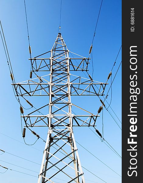 Power lines and electric pylon on a background of sky