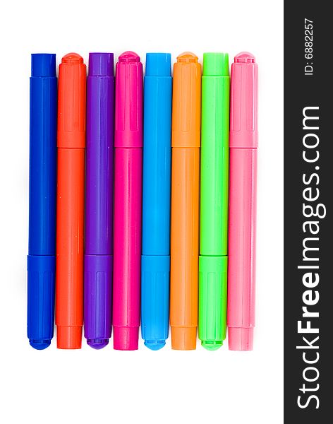 Varicoloured markers on the white isolated background