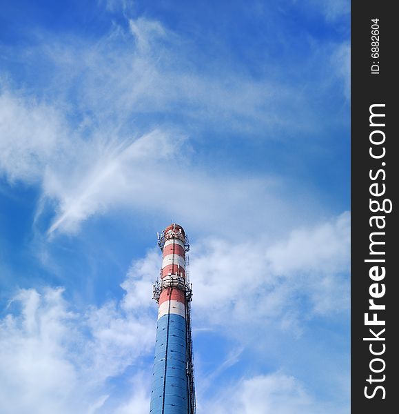 Urban chimney-stalk on a background cloudy sky. Urban chimney-stalk on a background cloudy sky