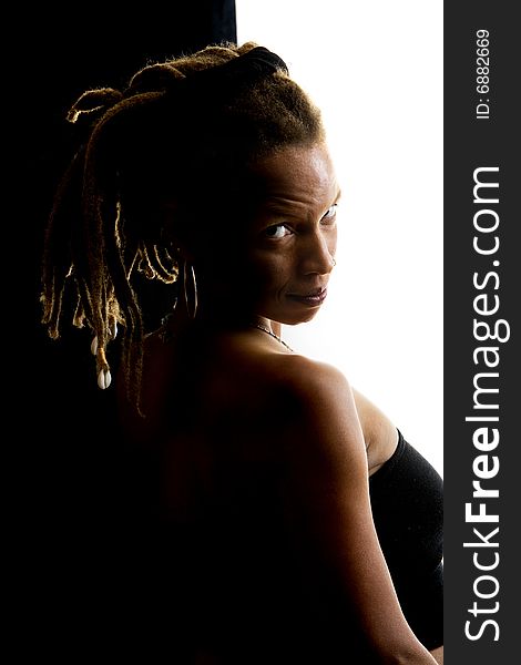 African American woman with dreadlocks against black and white wall. African American woman with dreadlocks against black and white wall