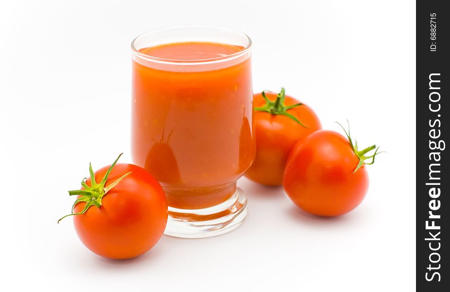 Glass of tomato juice and tomatoes