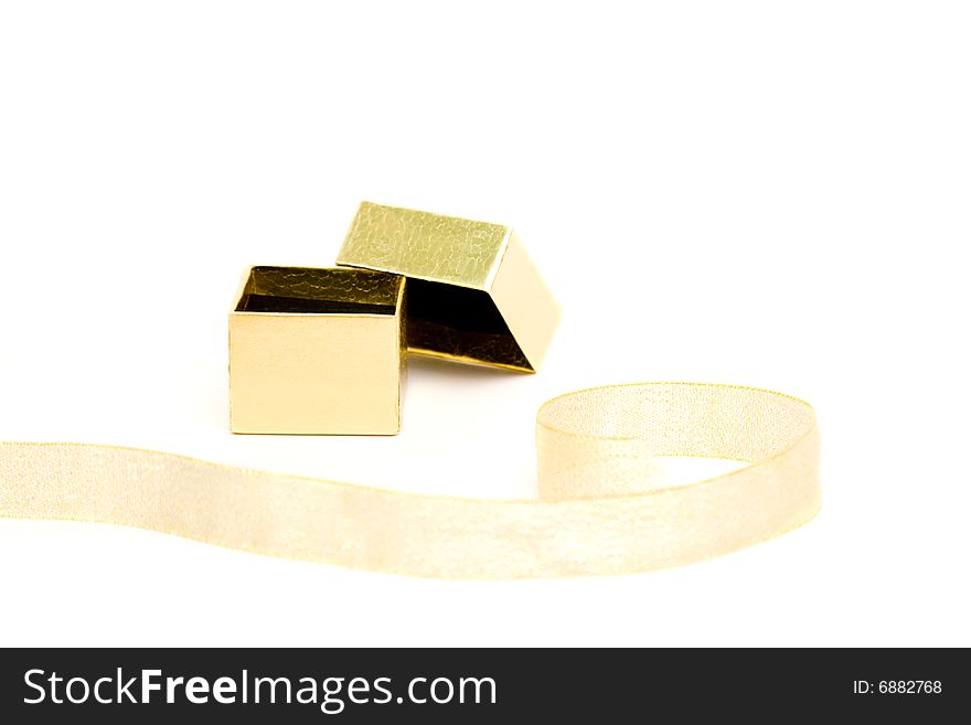 Small gold gift box with the ribbon on white