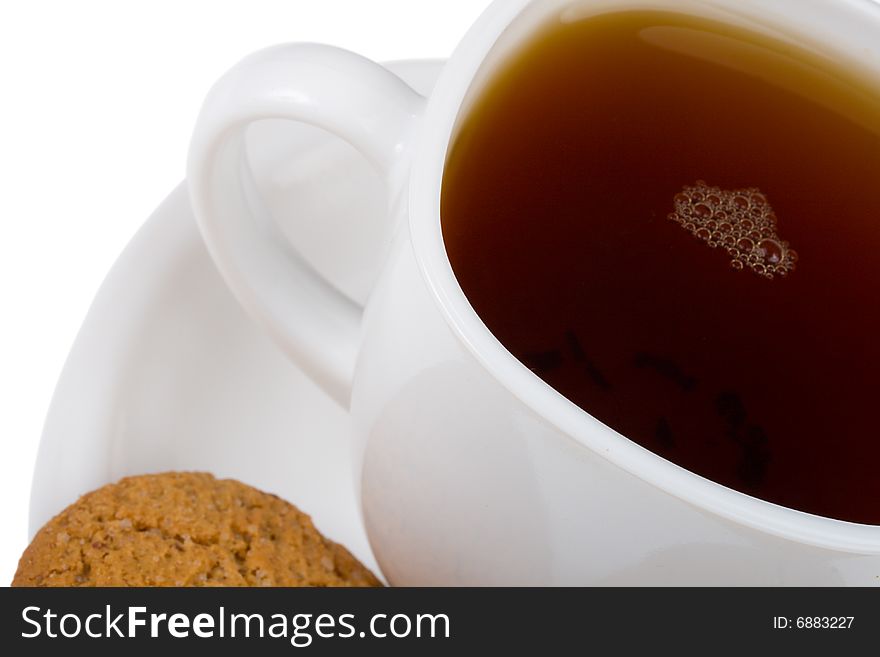 Close-up cup of tea and cookie, isolated on white