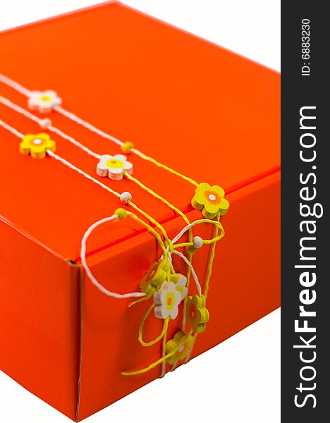 Orange gift box with decoration closeup