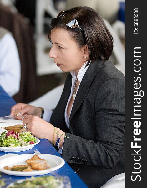 A businesswoman at table during the break at work, woman at table, people in restaurant. A businesswoman at table during the break at work, woman at table, people in restaurant