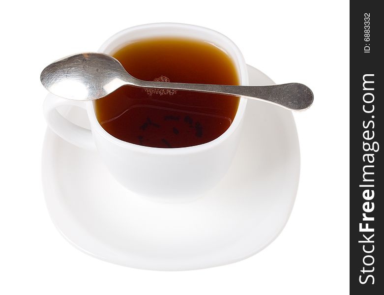 Cup and spoon with black tea, isolated on white