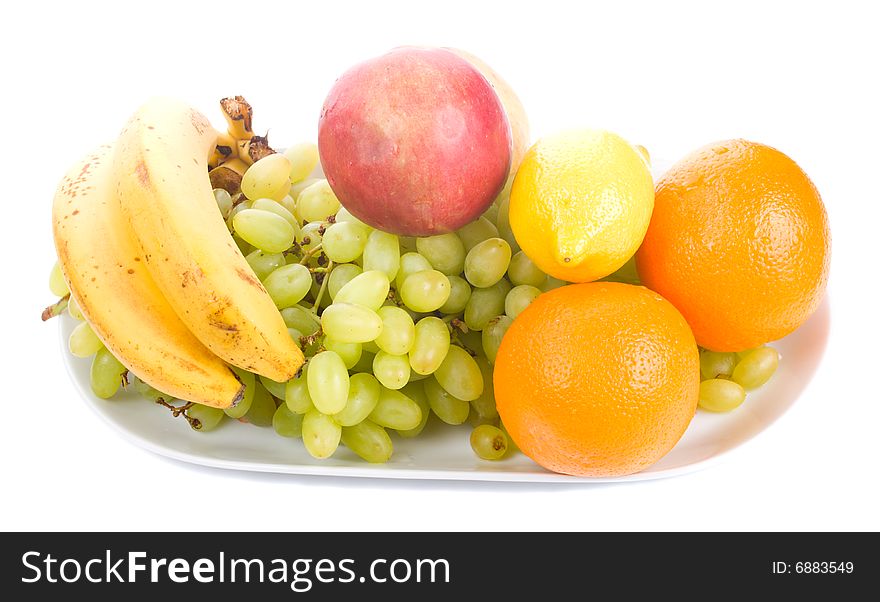 Close-up many fruits on plate, isolated on white