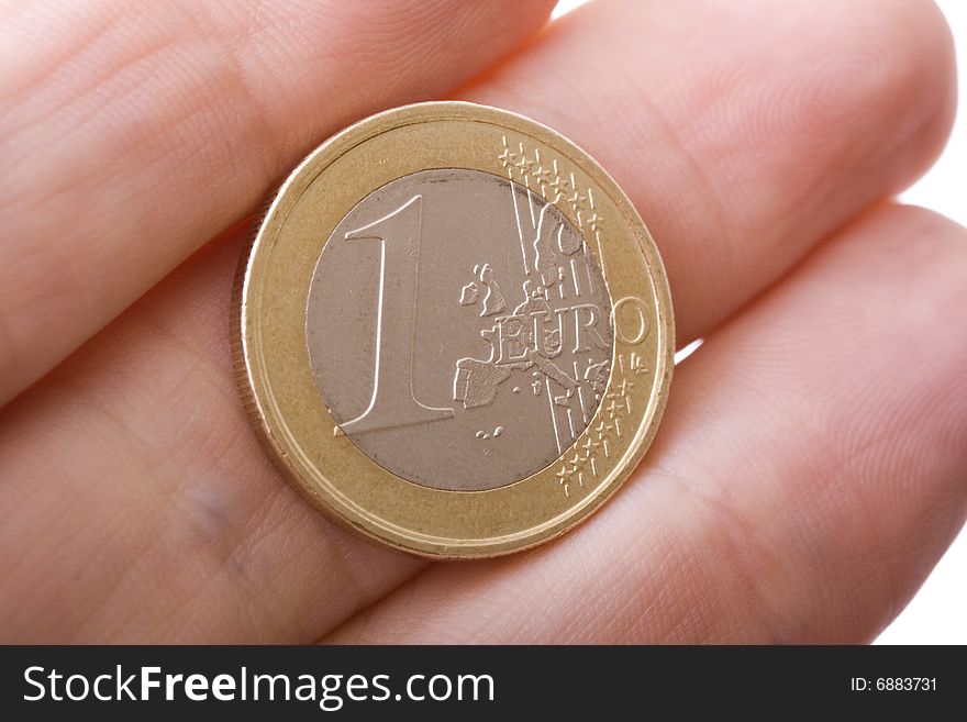 One Euro Coin in hand, close up. One Euro Coin in hand, close up