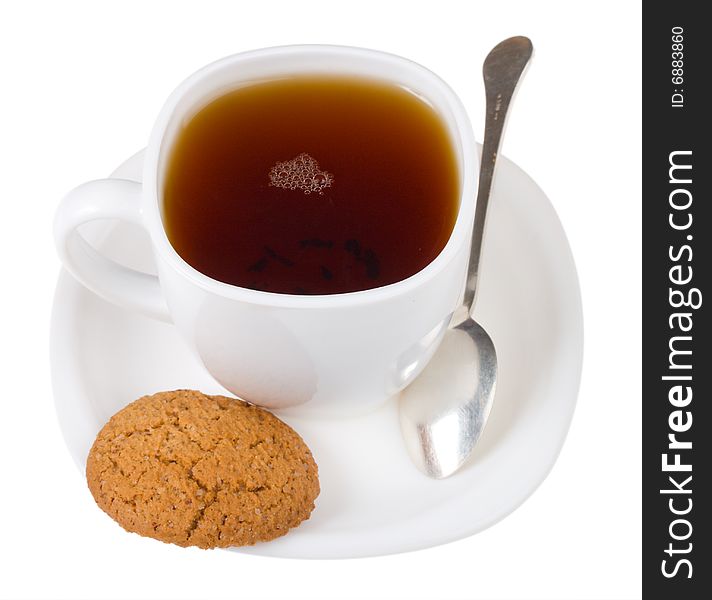 Tea and spoon with cookie, isolated on white