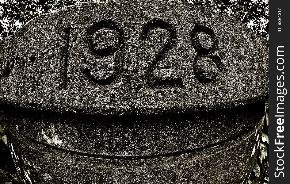 The number 1928 shot on a road marker