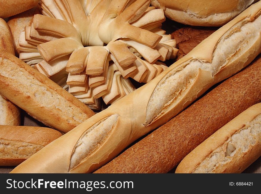 Different types of bread background. Focus on baguette.