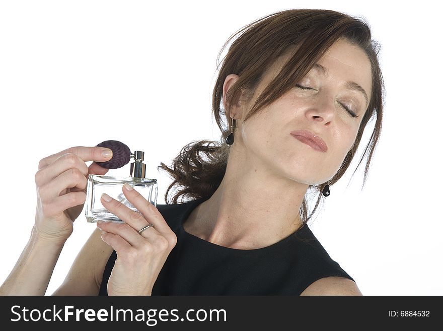 Sensual woman applying perfume on her body on a white background