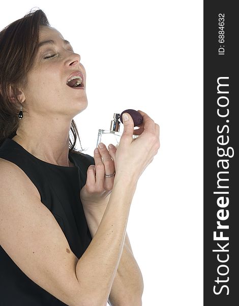 Sensual woman applying perfume on her body on a white background