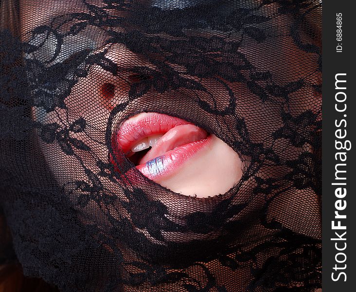 Woman face in a mask of black lace