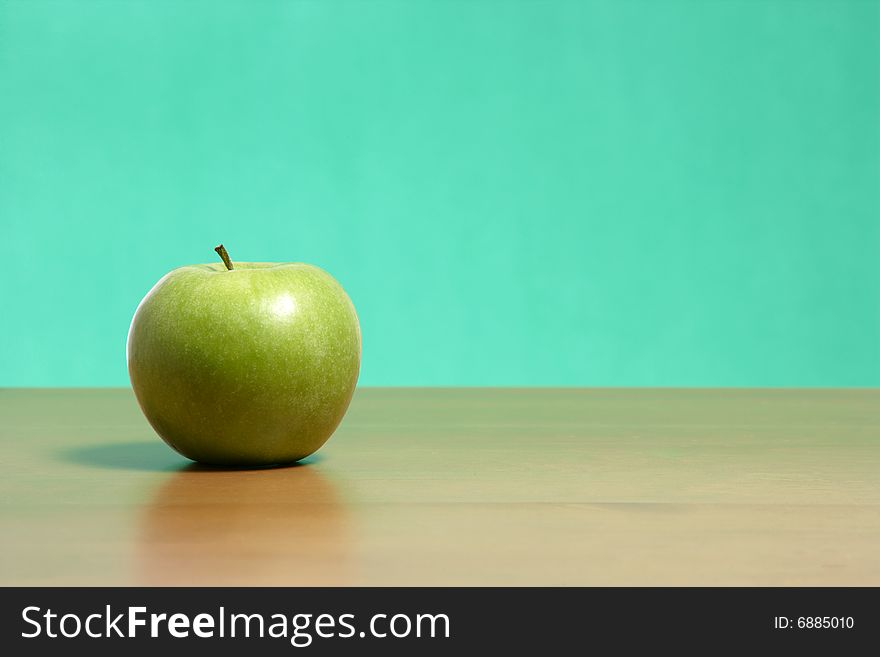 An apple on a desk in the classroom