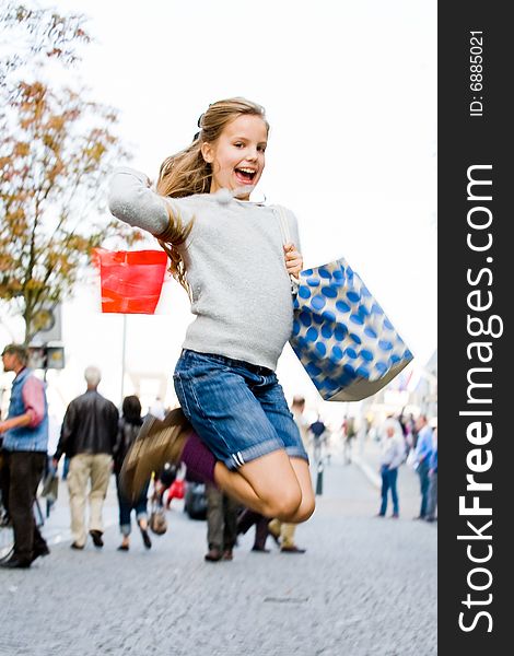 Young cute girl is jumping while shopping. Young cute girl is jumping while shopping