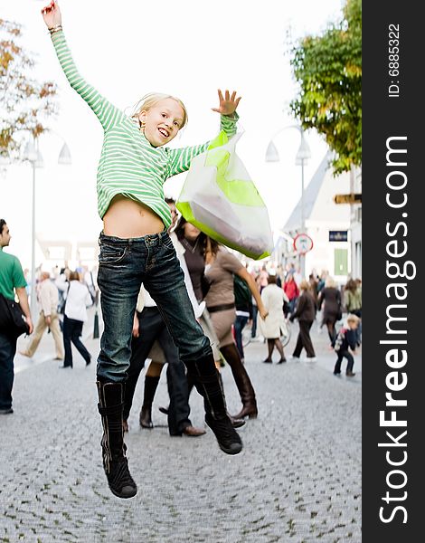 Young cute girl is jumping while shopping. Young cute girl is jumping while shopping