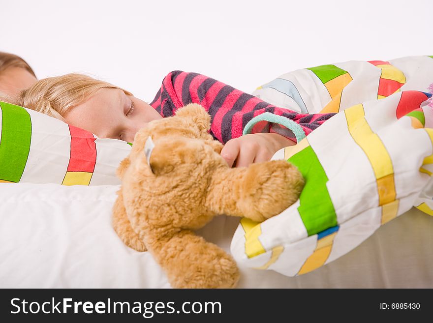 Two young children enjoying their colorful bed. Two young children enjoying their colorful bed