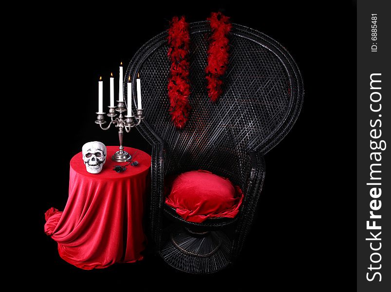 Chair and table with Halloween skull and candles. Chair and table with Halloween skull and candles
