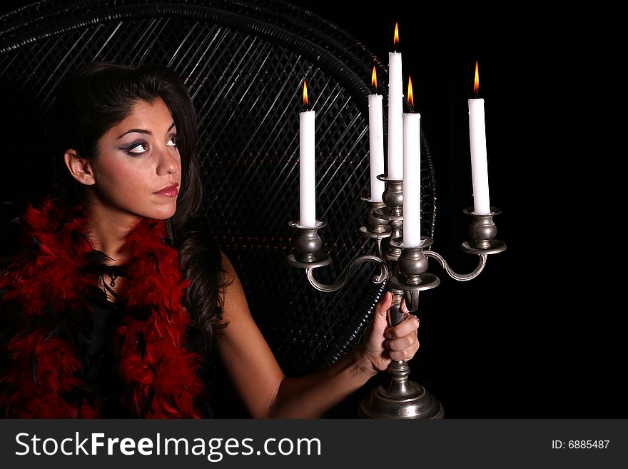 Attractive woman sitting in wicker chair viewing candles. Attractive woman sitting in wicker chair viewing candles