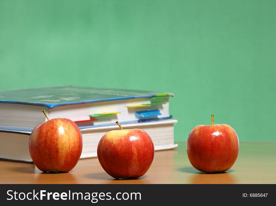 Apple On Stack Of Books In Classroom