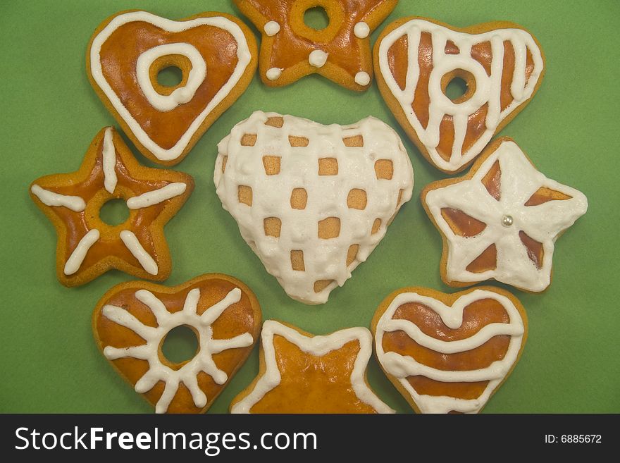 Close-up of gingerbread cookies in circle on green background. Close-up of gingerbread cookies in circle on green background