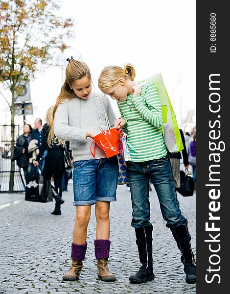 Two young children hanging around the streets while shopping. Two young children hanging around the streets while shopping