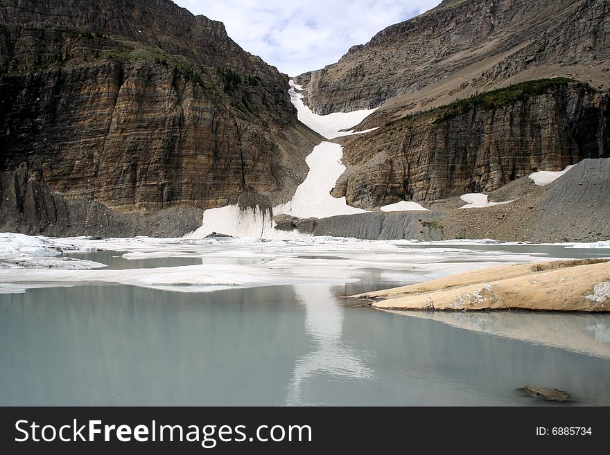 Glaciers slowly melt, forming a lake on top of the mountain. Glaciers slowly melt, forming a lake on top of the mountain